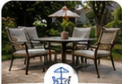 Concrete patio furnished with a dining table and chairs in a landscaped backyard